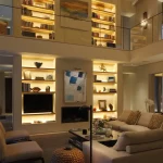 Double height living area with backlighting to shelving units