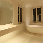 calming limestone bathroom with freestanding bath and floating basin