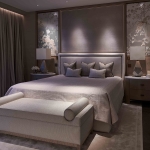 luxurious bedroom lighting with downlights to bedhead and on stool at bottom of the bed