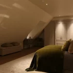 loft bedroom with downlit cupboards