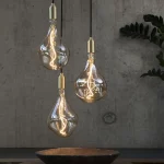 Hanging glass pendants above bowl on table