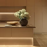 kitchen with strong lines of linear lighting above and below the kitchen island