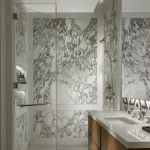 White marble bathroom with shower and basins