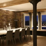 white dining table with downlights to the centre of the table