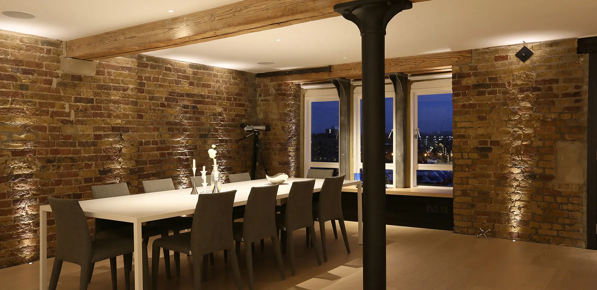 white dining table with downlights to the centre of the table