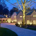 Driveway to country house with selective features lit