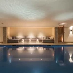 basement chalet swimming pool with uplits to wall and reflections on ceiling