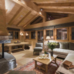 seating area in cosy chalet with arched beams lit with spotlights