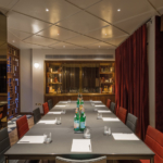 Conference room in hotel with red curtains and downlights onto table