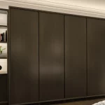 Bedroom wardrobes and joinery shelving unit lit with linear strip