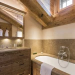Chalet bathroom with wooden beams and bath