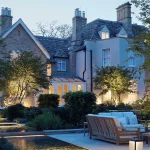 English Country Garden with water rills and uplit trees