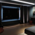 home cinema and music room with dark blue walls and lit guitars