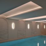 Pool with coffer ceiling detail and wall lights