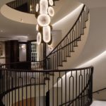 Spiral staircase with linear lighting and hanging pendant